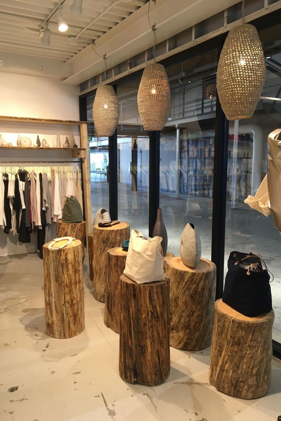 Custom wooden display racks within a modern clothing store interior design