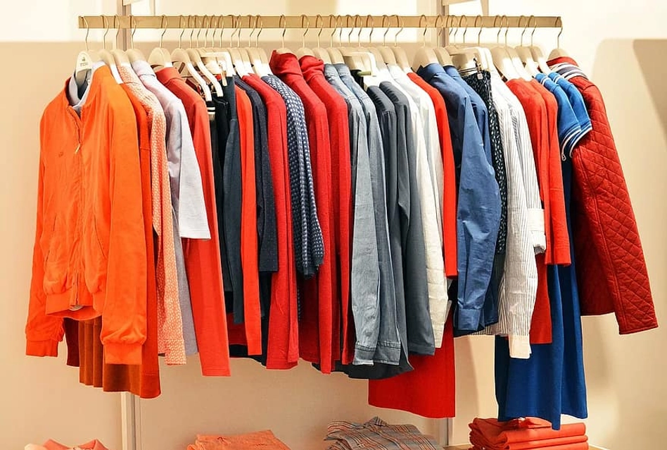 Tshirts, shirts and jackets hanging on a wall in a clothing boutique