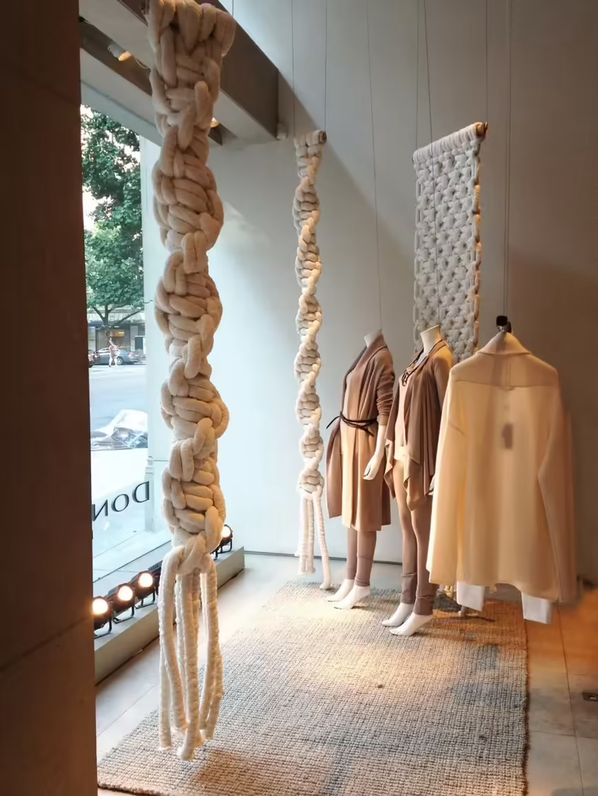 A clothing store window decorated with ropes