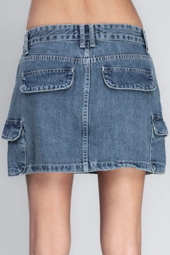 Bir model, BSL toptan giyim markasının bsl11975-denim-cargo-skirt toptan Etek ürününü sergiliyor.