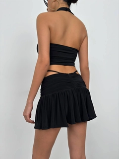 Bir model, Black Fashion toptan giyim markasının bla11534-cross-strap-blouse-black toptan Crop Top ürününü sergiliyor.