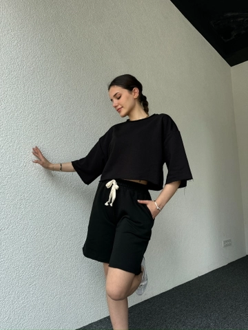 Bir model, CAPPITONE toptan giyim markasının  Pis Dikişli Sade Şortlu Takım Siyah
 toptan Takım ürününü sergiliyor.