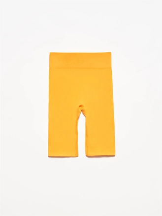A model wears 4048 - Orange Shorts, wholesale Shorts of Dilvin to display at Lonca