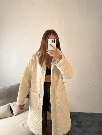 A model wears 29315 - Coat - Cream, wholesale undefined of Fame to display at Lonca
