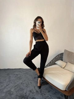 Bir model, Fame toptan giyim markasının 29365 - Sweatpants - Black toptan Eşofman Altı ürününü sergiliyor.