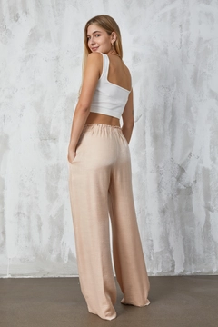 Bir model, First Angels toptan giyim markasının fan10310-stone-crinkle-glitter-loose-cut-trousers toptan Pantolon ürününü sergiliyor.