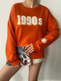 A wholesale clothing model wears fan10092-orange-printed-oversize-sweatshirt, Turkish wholesale Sweatshirt of First Angels