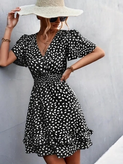 A wholesale clothing model wears jan14271-women's-short-sleeve-double-breasted-neck-waist-glitter-skirt-flounced-white-polka-dot-sandy-dress-black, Turkish wholesale Dress of Janes