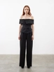 Bir model,  toptan giyim markasının jst10149-pleat-detailed-palazzo-trousers-black toptan  ürününü sergiliyor.