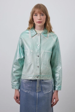 Bir model, Kadriye Baştürk toptan giyim markasının kdb10826-denim-jacket-green toptan Kot Ceket ürününü sergiliyor.