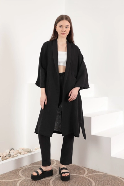 A model wears KAM10820 - Muslin Fabric Oversize Women's Kimono - Black, wholesale Kimono of Kaktus Moda to display at Lonca