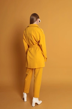 A wholesale clothing model wears kam11663-atlas-fabric-women's-trousers-with-elastic-waist-mustard, Turkish wholesale Pants of Kaktus Moda