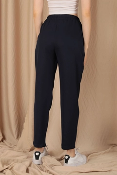 A wholesale clothing model wears kam11773-atlas-fabric-women's-trousers-with-elastic-waist-navy-blue, Turkish wholesale Pants of Kaktus Moda