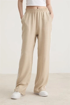 A wholesale clothing model wears lev10456-white-stripe-detailed-elastic-trousers-stone, Turkish wholesale Pants of Levure
