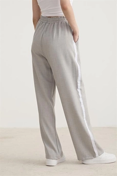 A wholesale clothing model wears lev10465-white-stripe-detailed-elastic-trousers-gray, Turkish wholesale Pants of Levure