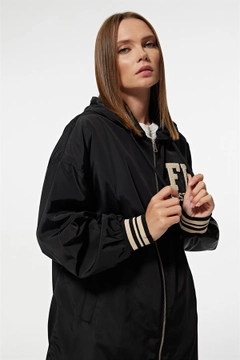 A wholesale clothing model wears lev10025-hooded-long-women's-college-trench-coat-black, Turkish wholesale Trenchcoat of Levure