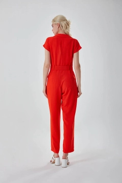 A wholesale clothing model wears MZC10024 - Belted Orange Crepe Jumpsuit - Orange, Turkish wholesale Jumpsuit of MZL Collection