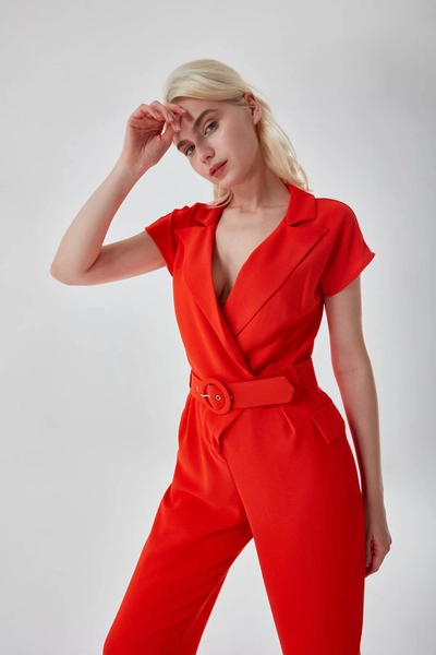 A model wears MZC10024 - Belted Orange Crepe Jumpsuit - Orange, wholesale Jumpsuit of MZL Collection to display at Lonca