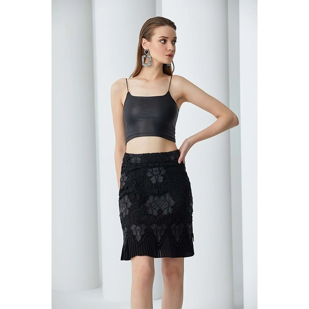 A model wears 23360 - Pleated Imitation Leather & Embroidery Short Skirt - Black, wholesale Skirt of Mare Style to display at Lonca