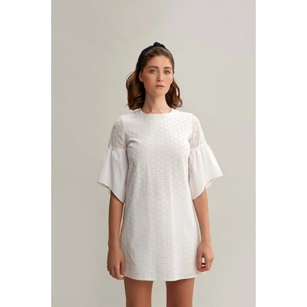 A model wears 33209 - Trumpet Sleeve Cotton Mini Embroidery Dress - White, wholesale undefined of Mare Style to display at Lonca
