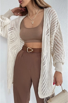 A wholesale clothing model wears max10888-long-cardigan-with-openwork-skirt-and-tassels, Turkish wholesale Cardigan of Maxi Modena