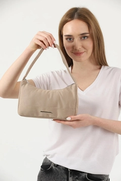 A wholesale clothing model wears mna10404-canvas-fabric-daily-baguette-hand-and-shoulder-bag-with-single-zipper-compartment, Turkish wholesale Bag of Mina Fashion