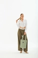 A wholesale clothing model wears mna10499-canvas-daily-hand-and-shoulder-bag-with-snap-closure-and-2-back-pockets-detail, Turkish wholesale  of 