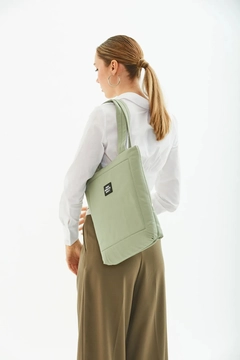 A wholesale clothing model wears mna10499-canvas-daily-hand-and-shoulder-bag-with-snap-closure-and-2-back-pockets-detail, Turkish wholesale Bag of Mina Fashion