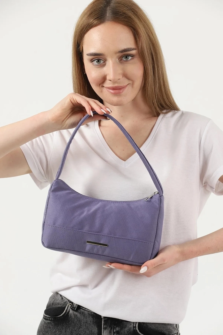 A wholesale clothing model wears mna10612-canvas-fabric-daily-baguette-hand-and-shoulder-bag-with-single-zipper-compartment, Turkish wholesale Bag of Mina Fashion