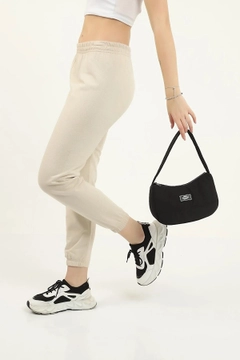 A wholesale clothing model wears mna10658-daily-sports-baguette-canvas-fabric-hand-and-shoulder-bag-with-single-zipper-compartment, Turkish wholesale Bag of Mina Fashion
