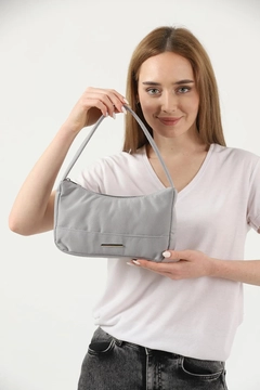 A wholesale clothing model wears mna10740-canvas-fabric-daily-baguette-hand-and-shoulder-bag-with-single-zipper-compartment, Turkish wholesale Bag of Mina Fashion