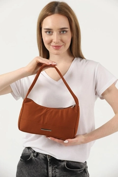 A wholesale clothing model wears mna10783-canvas-fabric-daily-baguette-hand-and-shoulder-bag-with-single-zipper-compartment, Turkish wholesale Bag of Mina Fashion
