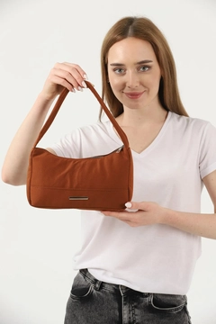 A wholesale clothing model wears mna10783-canvas-fabric-daily-baguette-hand-and-shoulder-bag-with-single-zipper-compartment, Turkish wholesale Bag of Mina Fashion