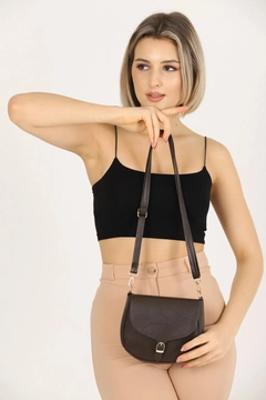 A wholesale clothing model wears mna10793-simple-and-stylish-snap-closure-crossbody-shoulder-bag-with-adjustable-strap, Turkish wholesale Bag of Mina Fashion