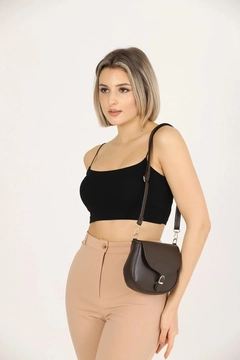 A wholesale clothing model wears mna10793-simple-and-stylish-snap-closure-crossbody-shoulder-bag-with-adjustable-strap, Turkish wholesale Bag of Mina Fashion
