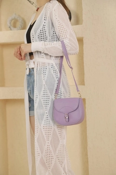 A wholesale clothing model wears mna10824-simple-and-stylish-snap-closure-crossbody-shoulder-bag-with-adjustable-strap, Turkish wholesale Bag of Mina Fashion