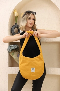 A wholesale clothing model wears mna10843-casual-model-canvas-fabric-daily-shoulder-bag-with-adjustable-fastening-strap, Turkish wholesale Bag of Mina Fashion