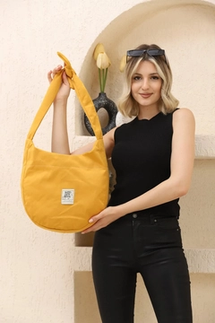 A wholesale clothing model wears mna10843-casual-model-canvas-fabric-daily-shoulder-bag-with-adjustable-fastening-strap, Turkish wholesale Bag of Mina Fashion