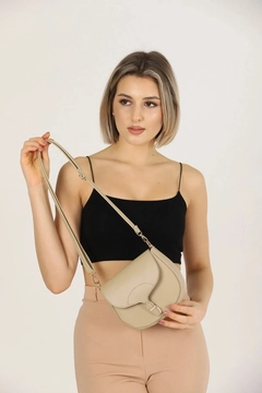 A wholesale clothing model wears mna10869-simple-and-stylish-snap-closure-crossbody-shoulder-bag-with-adjustable-strap, Turkish wholesale Bag of Mina Fashion