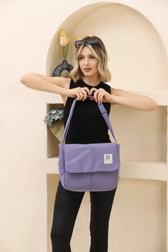A wholesale clothing model wears mna10877-postman-model-5-compartment-adjustable-strap-daily-unisex-arm-and-shoulder-bag, Turkish wholesale Bag of Mina Fashion