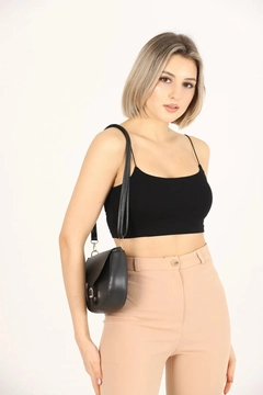 A wholesale clothing model wears mna10956-simple-and-stylish-snap-closure-crossbody-shoulder-bag-with-adjustable-strap, Turkish wholesale Bag of Mina Fashion