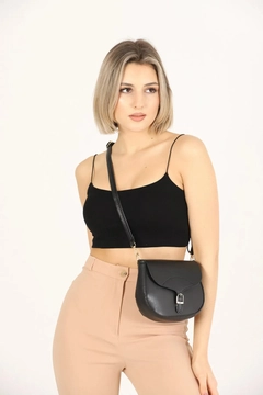 A wholesale clothing model wears mna10956-simple-and-stylish-snap-closure-crossbody-shoulder-bag-with-adjustable-strap, Turkish wholesale Bag of Mina Fashion