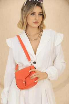 A wholesale clothing model wears mna10967-simple-and-stylish-snap-closure-crossbody-shoulder-bag-with-adjustable-strap, Turkish wholesale Bag of Mina Fashion