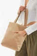 A wholesale clothing model wears mna10026-canvas-daily-hand-and-shoulder-bag-with-snap-closure-and-2-back-pockets-detail, Turkish wholesale  of 
