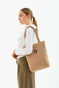 A wholesale clothing model wears mna10026-canvas-daily-hand-and-shoulder-bag-with-snap-closure-and-2-back-pockets-detail, Turkish wholesale Bag of Mina Fashion
