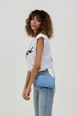 A wholesale clothing model wears mna10054-mini-urban-cross-strap-single-compartment-faux-leather-shoulder-bag, Turkish wholesale  of 