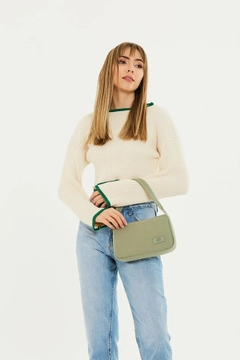 A wholesale clothing model wears mna10059-single-compartment-canvas-fabric-daily-sports-baguette-hand-and-shoulder-bag, Turkish wholesale Bag of Mina Fashion