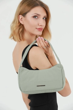 A wholesale clothing model wears mna10067-canvas-fabric-daily-baguette-hand-and-shoulder-bag-with-single-zipper-compartment, Turkish wholesale Bag of Mina Fashion