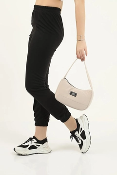 A wholesale clothing model wears mna10073-daily-sports-baguette-canvas-fabric-hand-and-shoulder-bag-with-single-zipper-compartment, Turkish wholesale Bag of Mina Fashion