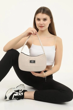 A wholesale clothing model wears mna10073-daily-sports-baguette-canvas-fabric-hand-and-shoulder-bag-with-single-zipper-compartment, Turkish wholesale Bag of Mina Fashion